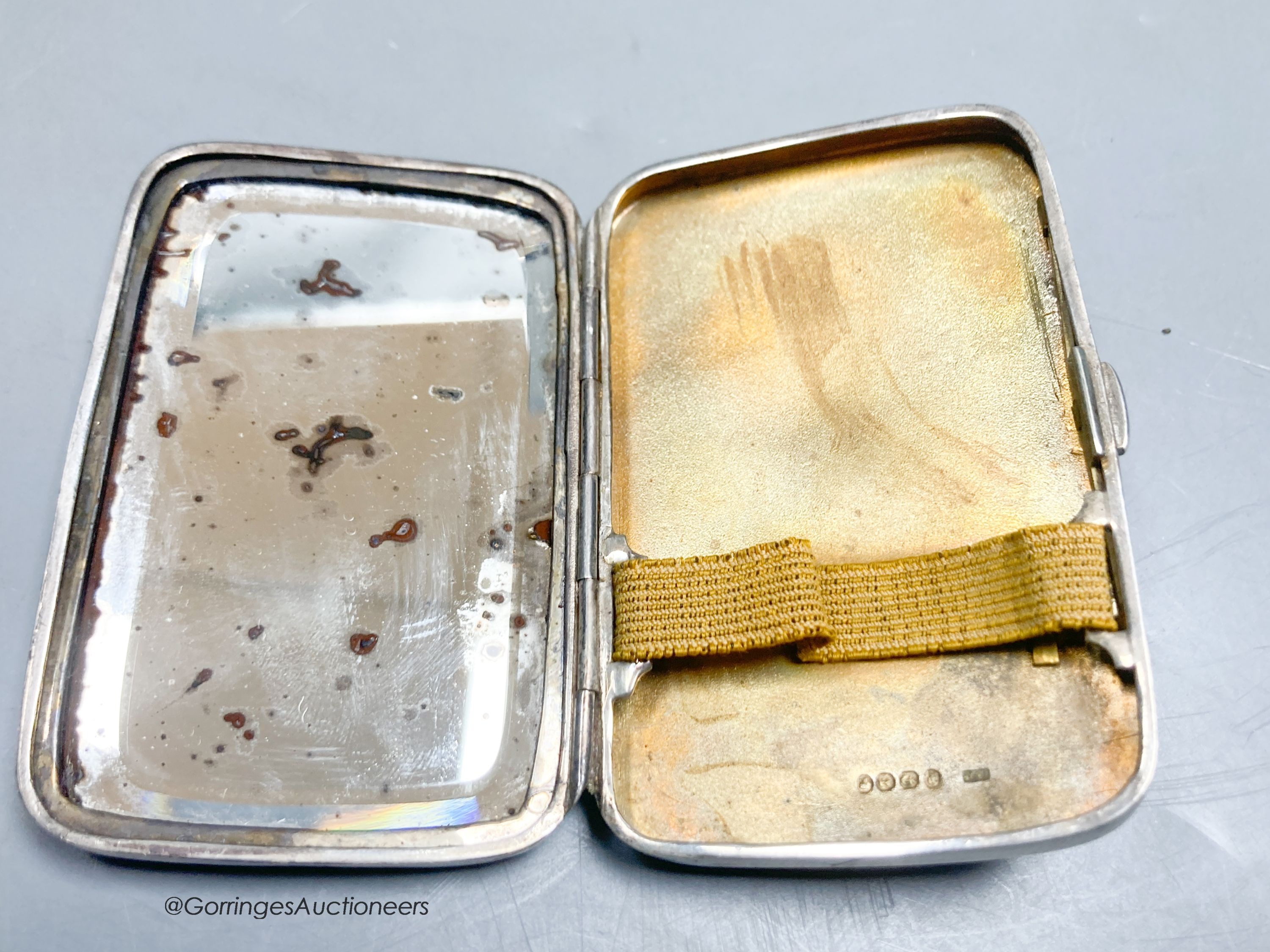 A late Victorian embossed silver shaped rectangular cigarette case, with mirrored interior, Birmingham, 1889, 81mm.